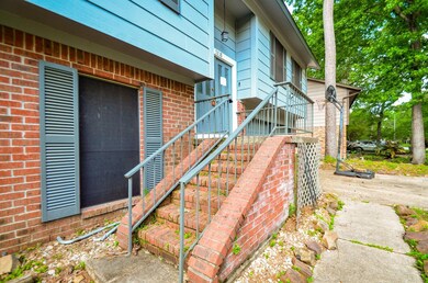 A sturdy brick stairway leads to the covered front