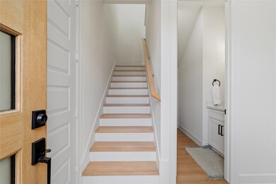 Step into elegance as you enter through the glass-paneled front door, where the foyer welcomes you with a sense of grace and sophistication. Illuminate your path with natural light streaming through, setting the tone for the exquisite living space that awaits beyond.
