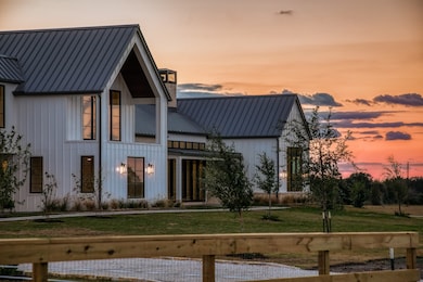 Evening settles over Round Top, and the home comes alive in the soft glow of its own light. Clean lines, perfect symmetry, and quiet restraint. Welcome to 130 Round Top Farms Drive.