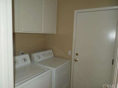 Laundry room with cupboards and counter on other s