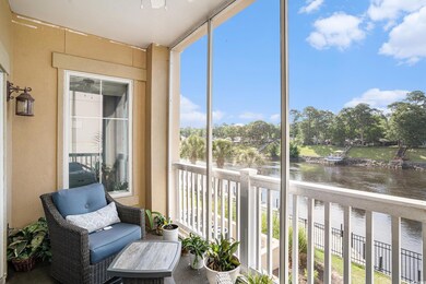 Sunroom with a water view and a ceiling fan