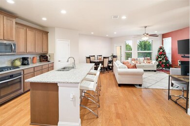 The large kitchen has numerous cabinets, an island