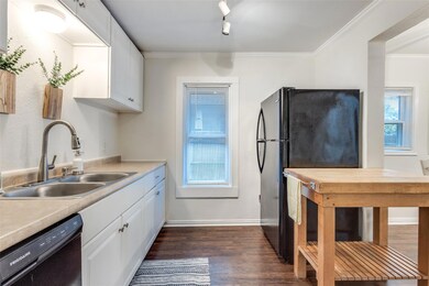 Kitchen featuring white cabinets, sink, dark hardw