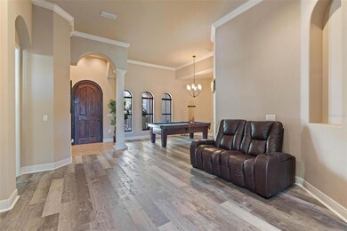 Entrance to formal living/dining. Pilar, crown molding, decorative door.