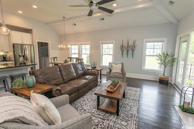 Living room featuring washing machine and clothes 
