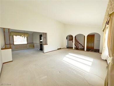 Living room with open floor plan to dining room