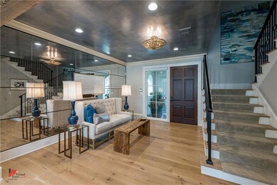 Beautiful  entry has mirrored wall, recessed light
