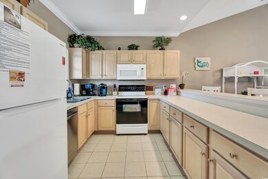Kitchen featuring light brown cabinets, light tile