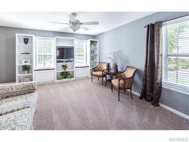 Living room featuring built in bookcases, new carp