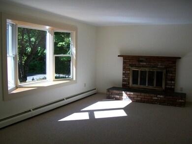 Living room with fireplace & bay window