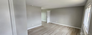 Living room, with larger picture window, coat clos