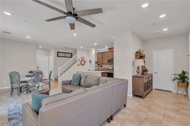 Living room with ceiling fan, stairway, recessed l