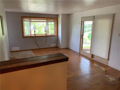 Hard wood floors and french doors leading to the s