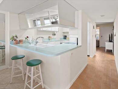 Kitchen featuring sink, a breakfast bar, white cab