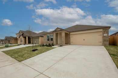 View of front of property with brick siding, concrete driveway, and an attached garage