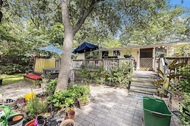 Back of house with a patio area and a deck