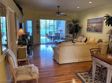 Living area with wood finished floors, ceiling fan