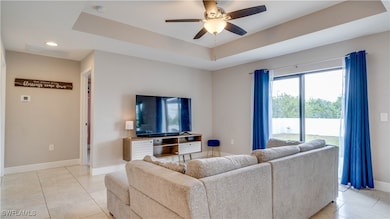 Living area with light tile patterned floors, ceil