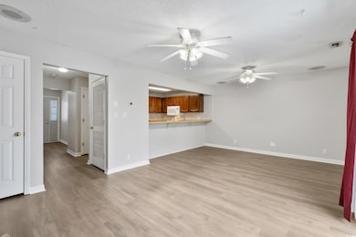 Unfurnished living room with visible vents, basebo