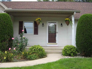 Covered front porch and roses and perennials welco