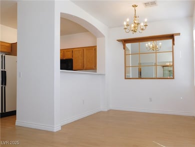 Unfurnished dining area with a chandelier, light w