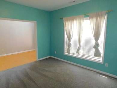 Unfurnished room with carpet floors and plenty of natural light