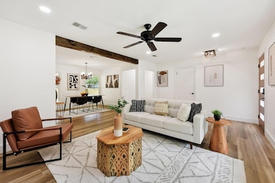Living room with beamed ceiling, ceiling fan with