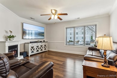 Living room with visible vents, ornamental molding