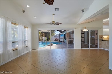 Unfurnished room featuring lofted ceiling, light t