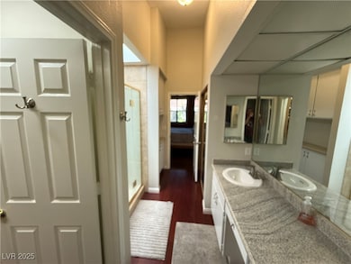 Bathroom featuring vanity, wood finished floors, a