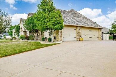 View of front of property featuring a garage and a front lawn