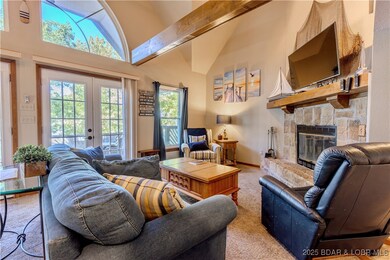 Cozy living room with open beams and fireplace.