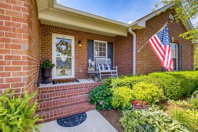 Nice rocking chair front porch and beautiful landscaping.