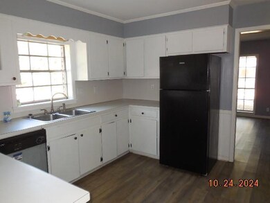 Kitchen with dark wood-type flooring, white cabine