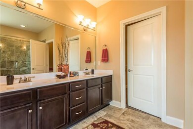 Large Master Bath with double vanities, tile shower, & floor.