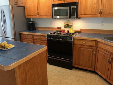 Kitchen. TILE COUNTERS AND  OAK CABINETS. NEWER RE