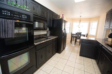 Gorgeous Granite Counter Tops and Black Appliances
