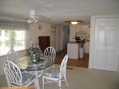 Dining area looking to kitchen