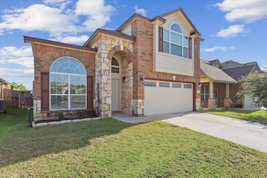 View of front facade with a garage, driveway, bri