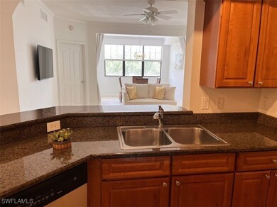 Kitchen featuring stainless steel dishwasher, dark