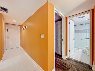Hallway with tile patterned floors and recessed lighting