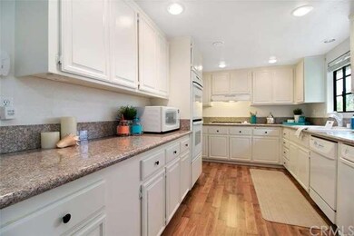 bright and cheery kitchen looks out onto front gre
