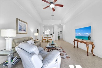 Living area with tile flooring throughout living area, crown molding and ceiling fan w/ light