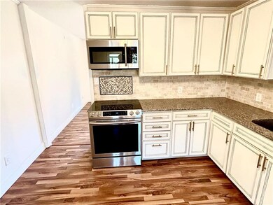Kitchen featuring tasteful backsplash, hardwood / 