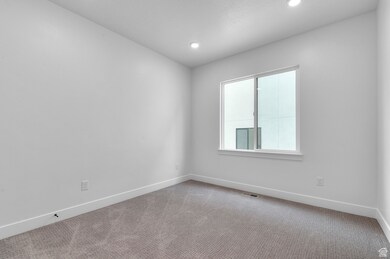 Empty room featuring carpet floors, recessed lighting, and a textured ceiling