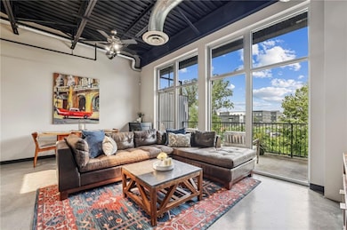 Living room featuring finished concrete floors and baseboards