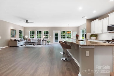 Long hallway passing the bedrooms and formal dining room to oversized family room!