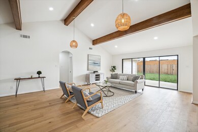 Stylish living room with rattan lighting, a 12’ wi