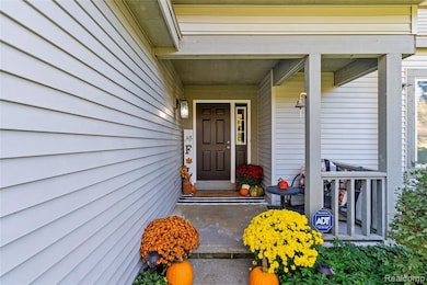 View of exterior entry featuring covered porch