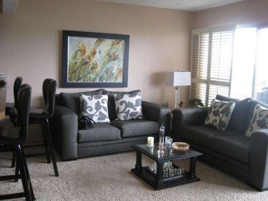 Cozy living room opening to ocean view balcony